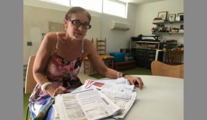 Cornelia Stumpf looks over old power bills. Since 2011, when the fee was initiated, she’s paid about $500 for the troubled nuclear Plant Vogtle. Photo by Mary Landers/Savannah Morning News